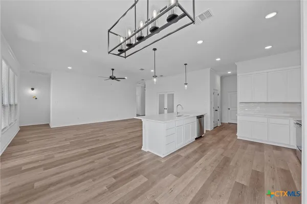 a view of kitchen and hall with wooden floor