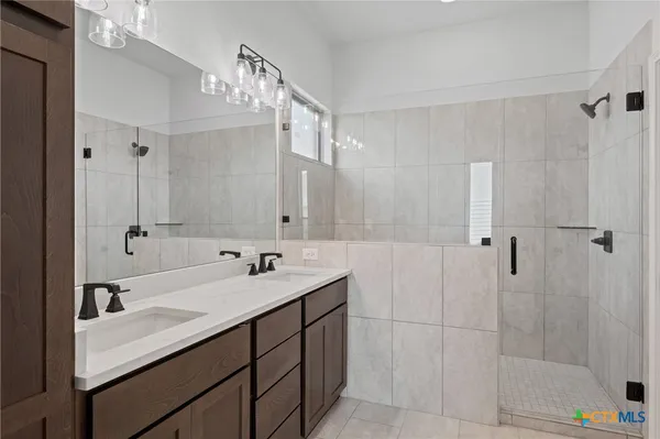 a bathroom with a sink double vanity and shower