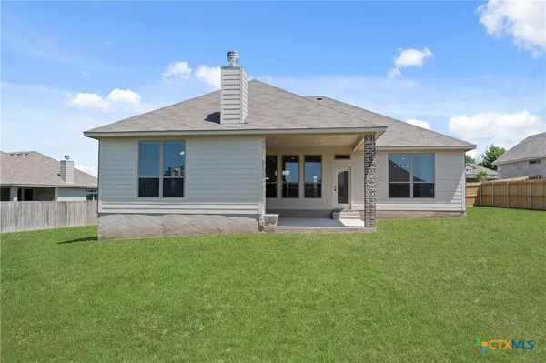 a front view of a house with a yard and porch