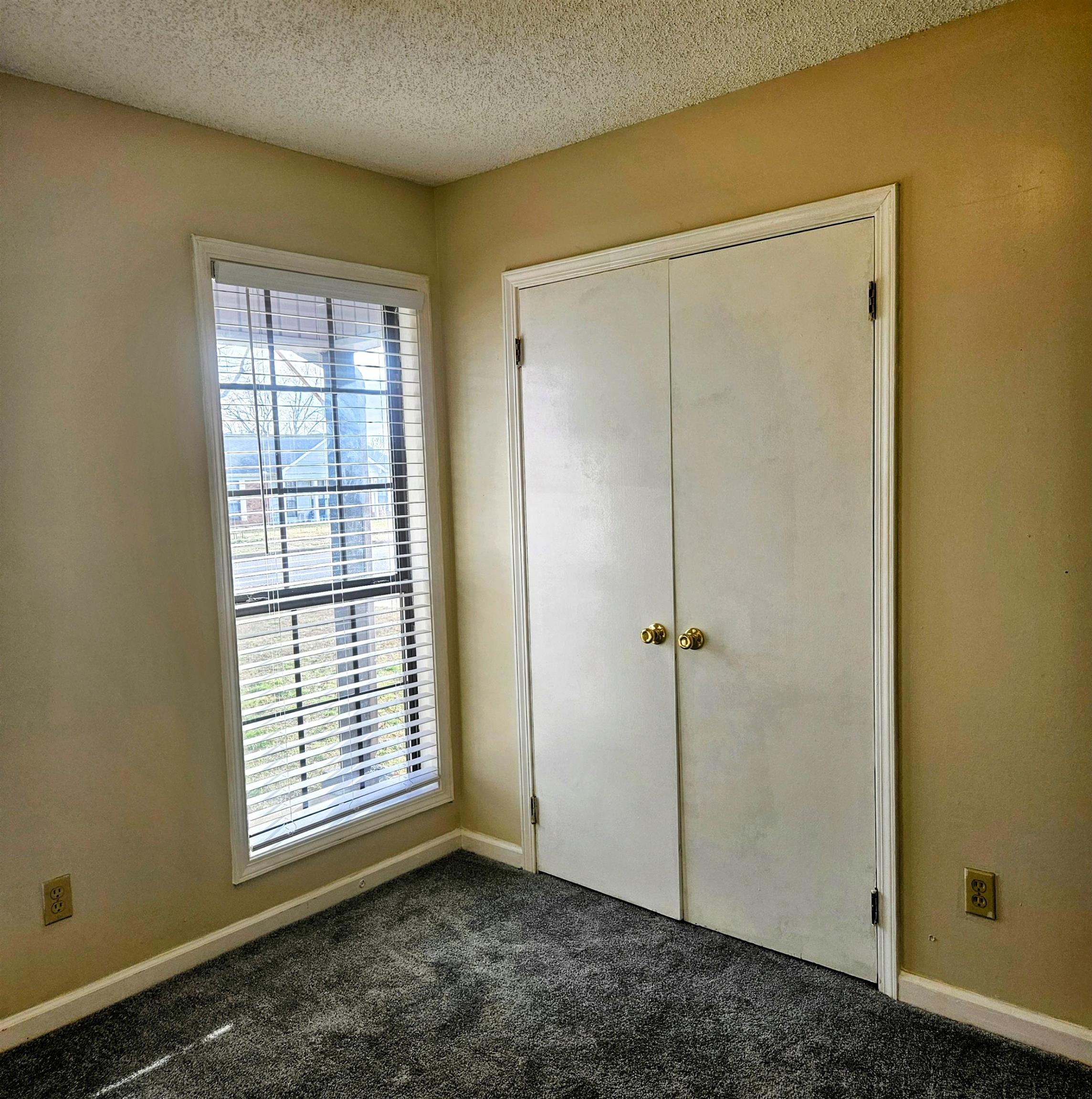4262 Water Briar Road Millington, TN 38053 - Photo 17 of 21 Unfurnished bedroom with dark colored carpet, a closet, a textured ceiling, and baseboards