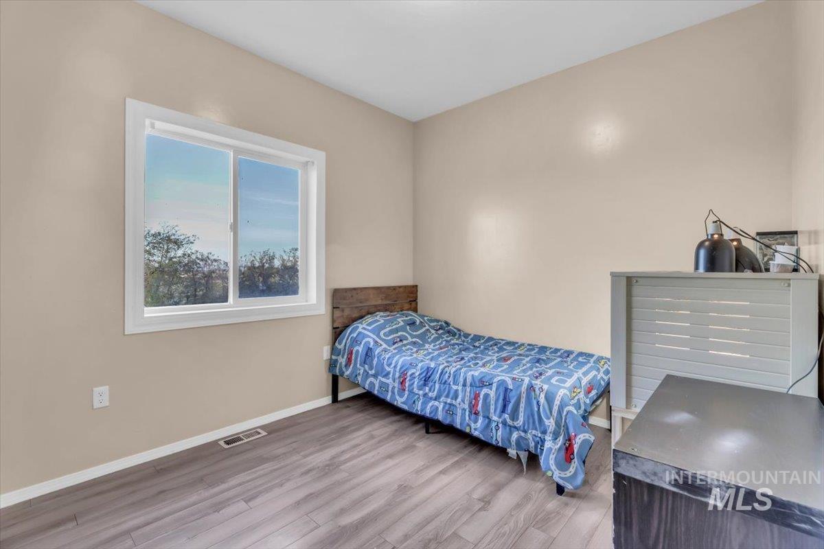 15046 Burger Lane Caldwell, ID 83607 - Photo 11 of 31 Bedroom with baseboards and wood finished floors