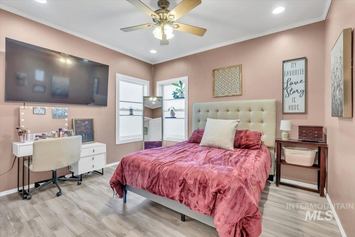 15046 Burger Lane Caldwell, ID 83607 - Photo 9 of 31 Bedroom with ornamental molding, recessed lighting, a ceiling fan, light wood finished floors, and an office area