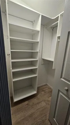 a view of a livingroom with an empty space and a window