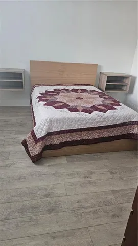 a bedroom with a bed and cabinet