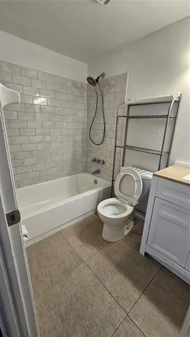 a spacious bedroom with a bed and a dresser