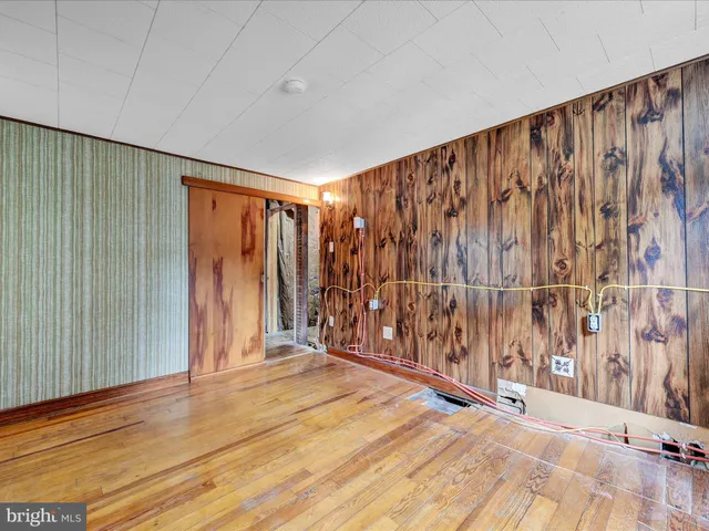 a room with furniture pool table and a window