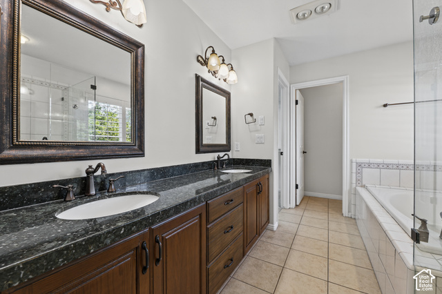 10664 Trail Ridge Circle Sandy, UT 84092 - Photo 29 of 113 Double vanity with dark stone-finish countertop, wood-finish cabinetry, and oil-rubbed bronze fixtures