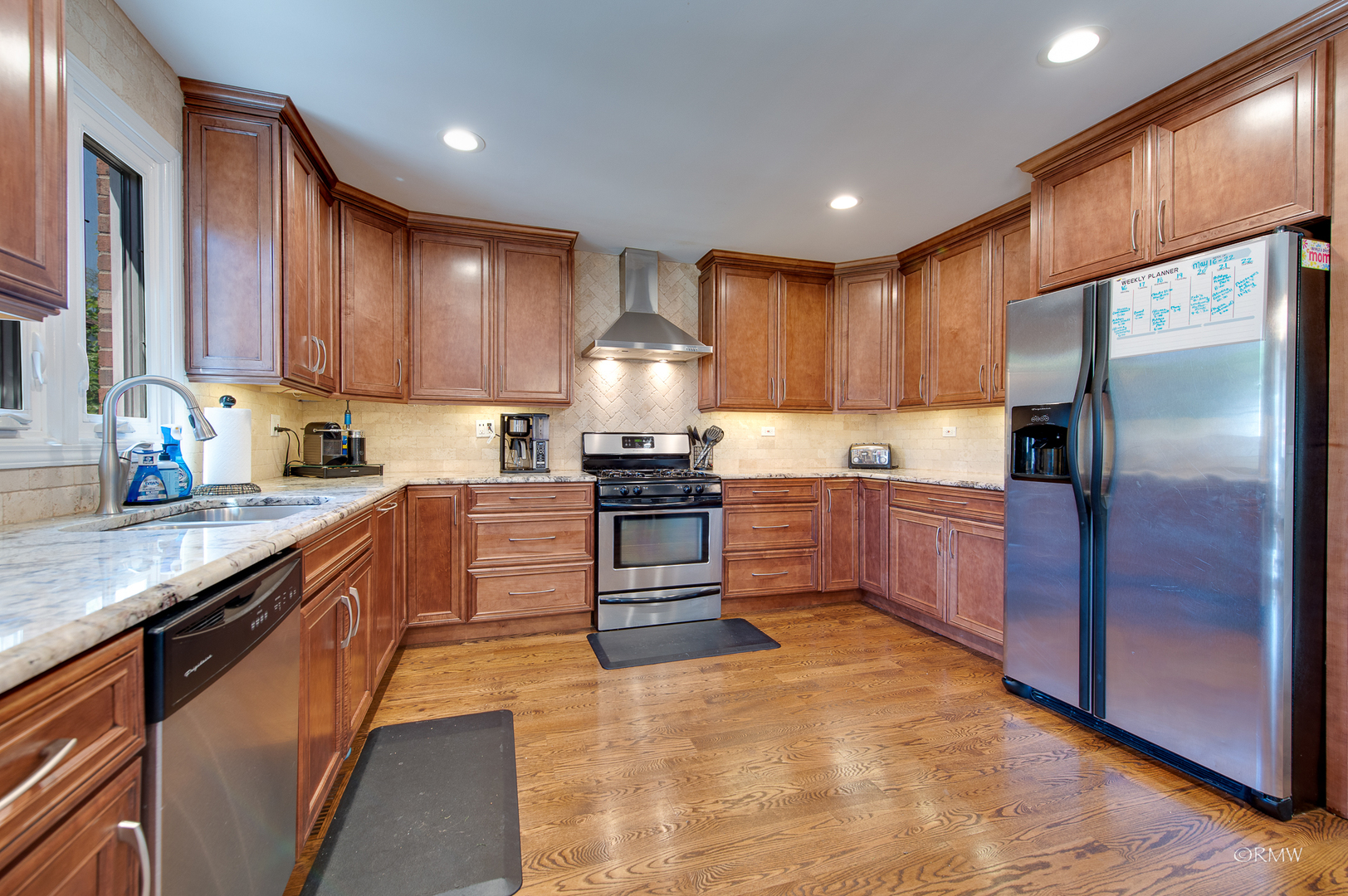 1205 Sable Drive Addison, IL 60101 - Photo 3 of 44 a kitchen with granite countertop stainless steel appliances and wooden cabinets