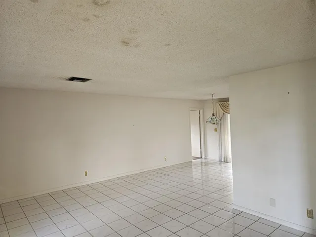 a kitchen with a cabinets and white appliances