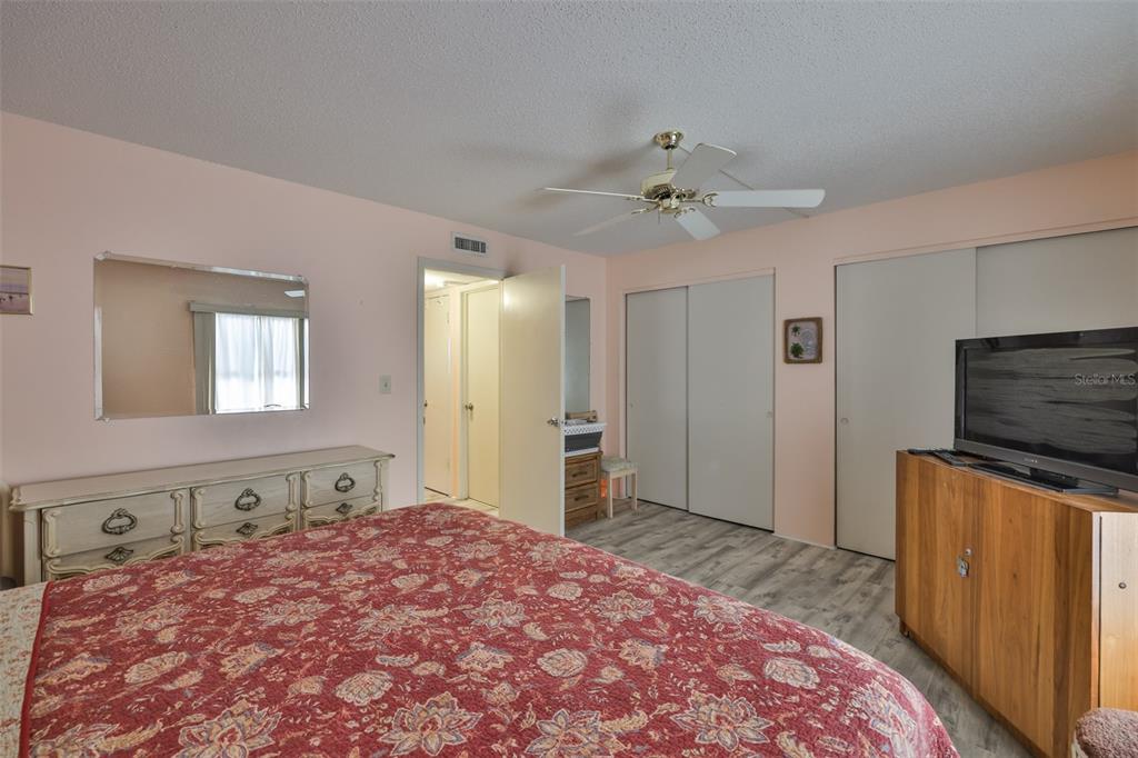 12760 Indian Rocks Road, Unit 413 Largo, FL 33774 - Photo 15 of 27 a bedroom with a bed and a flat screen tv