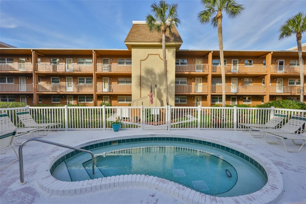 12760 Indian Rocks Road, Unit 413 Largo, FL 33774 - Photo 18 of 27 a view of a house with a backyard and porch