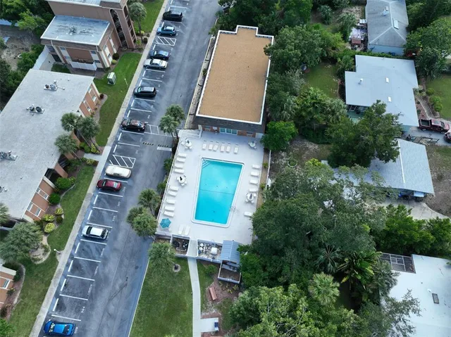 an aerial view of a house with a yard