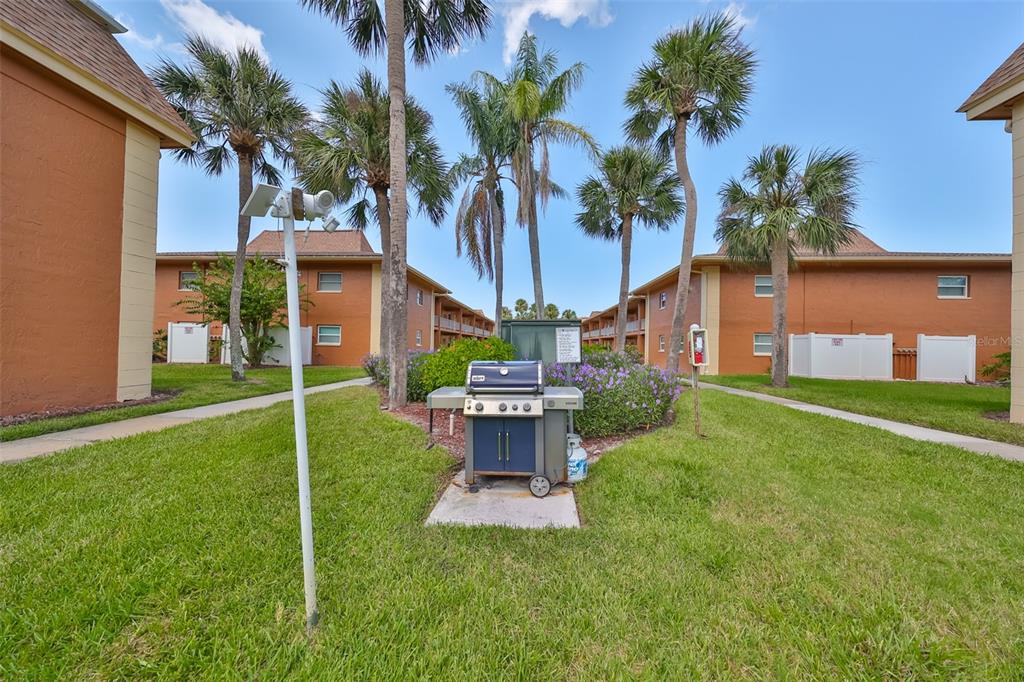 12760 Indian Rocks Road, Unit 413 Largo, FL 33774 - Photo 21 of 27 a view of a house with a yard and palm trees