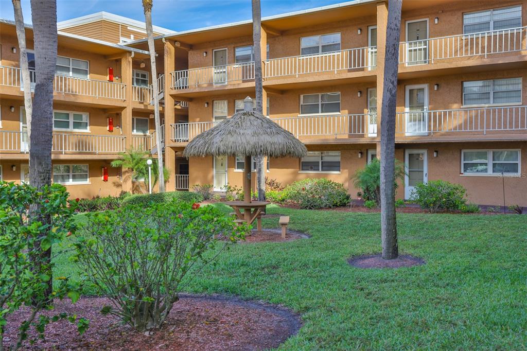 12760 Indian Rocks Road, Unit 413 Largo, FL 33774 - Photo 22 of 27 a front view of a building with a yard