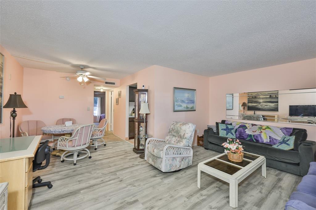 12760 Indian Rocks Road, Unit 413 Largo, FL 33774 - Photo 4 of 27 a living room with furniture and a flat screen tv