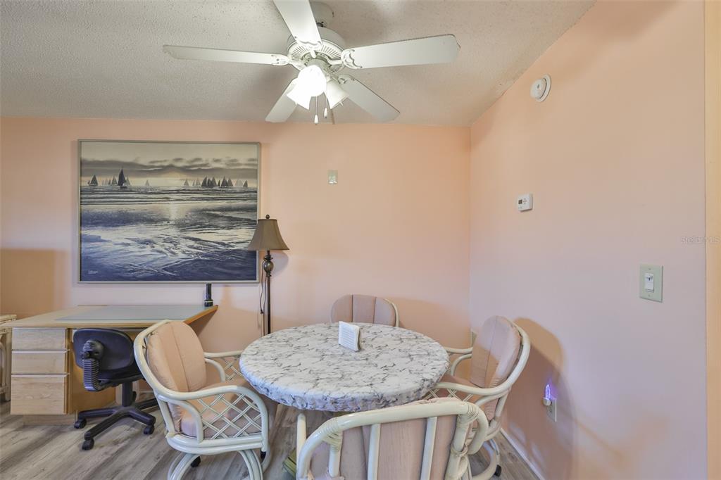 12760 Indian Rocks Road, Unit 413 Largo, FL 33774 - Photo 8 of 27 a view of a dining room with furniture and chandelier