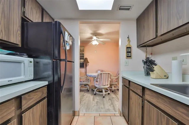 a kitchen with a refrigerator and cabinets