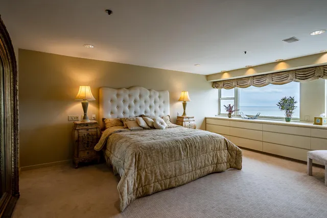 a bed room with a bed and a large window