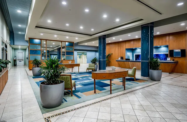 a lobby with furniture and a potted plant