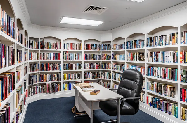 a workspace with a book shelf and a book shelf
