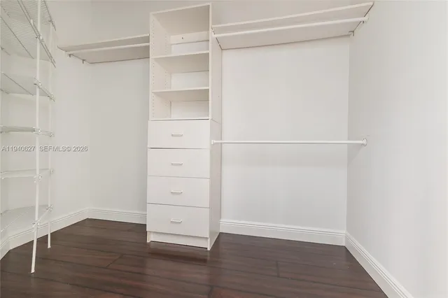 a bathroom with a tub a sink and a large window