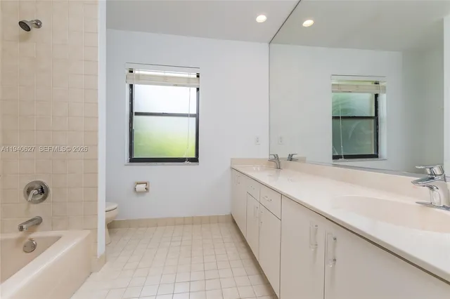 an empty room with wooden floor window and hallway