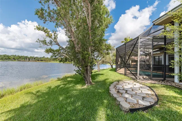 a view of a backyard with swimming pool