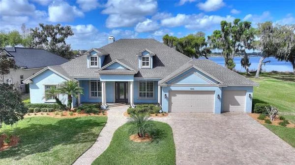 an aerial view of a house with garden space and lake view