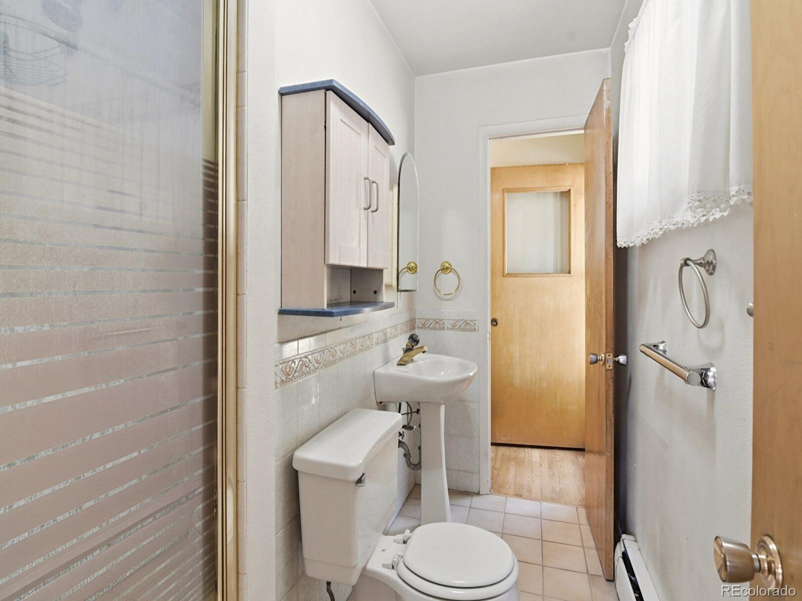 2830 Kerr Gulch Road Evergreen, CO 80439 - Photo 23 of 48 a bathroom with a sink a toilet and shower