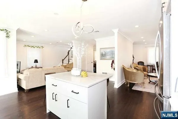 a living room with couches chairs and couches with wooden floor