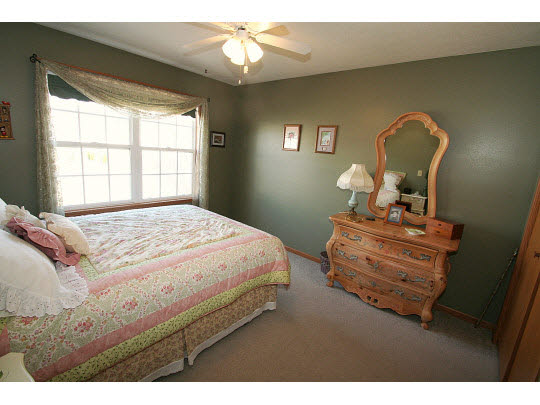 10980 Chicory Ridge Way Roscoe, IL 61073 - Photo 8 of 11 a bedroom with a bed wooden floor and window