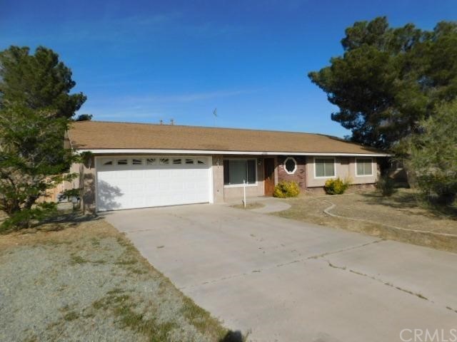 21186 Cowichen Road Apple Valley, CA 92308 - Photo 1 of 1 a front view of a house with a yard and garage
