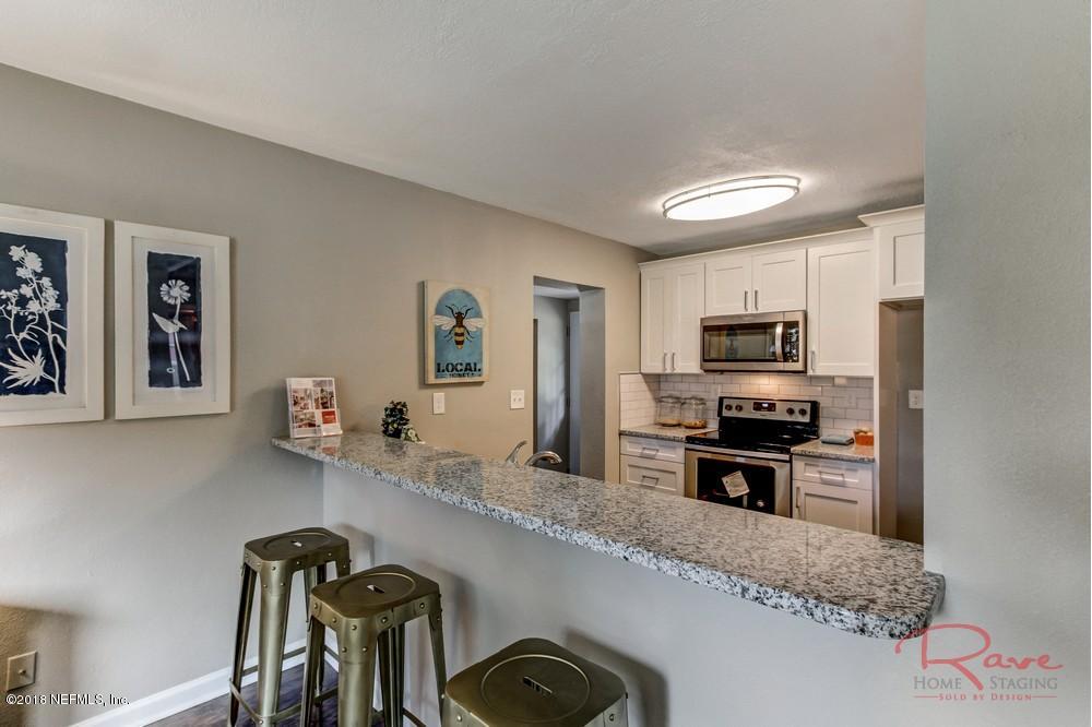 6758 Orkney Road Jacksonville, FL 32211 - Photo 8 of 23 a kitchen with granite countertop a refrigerator stove and sink