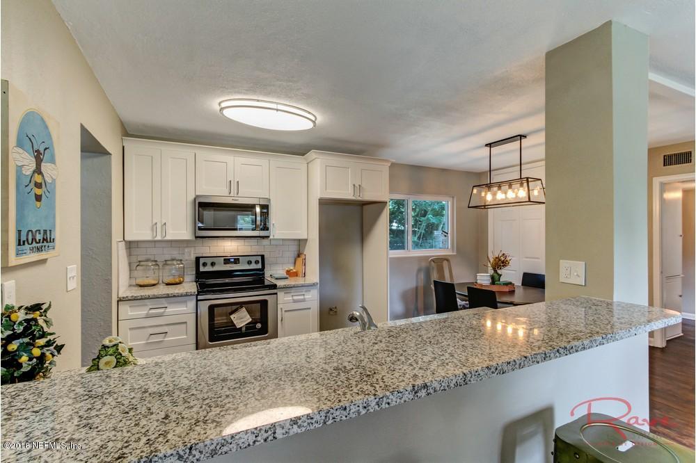 6758 Orkney Road Jacksonville, FL 32211 - Photo 9 of 23 a kitchen with stainless steel appliances granite countertop a stove refrigerator and sink
