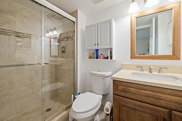 a bathroom with a sink a toilet and shower