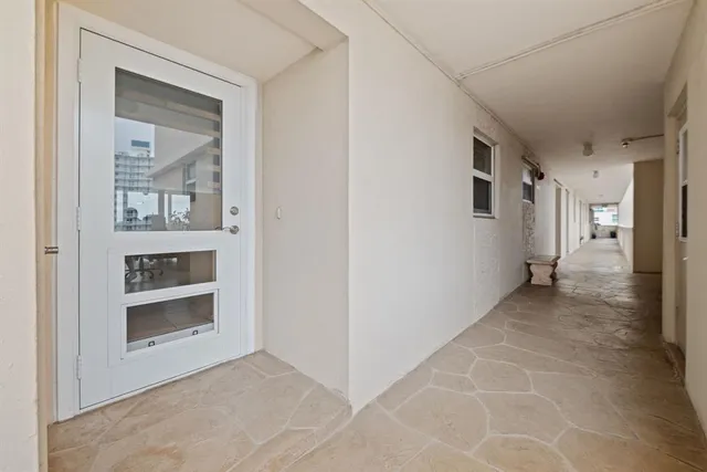 a view of a hallway with an empty room and fire place