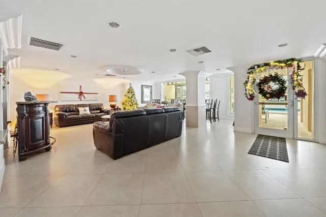 a living room with couches and kitchen view