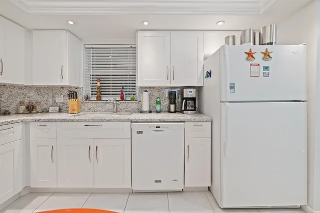 a white refrigerator freezer sitting in a kitchen