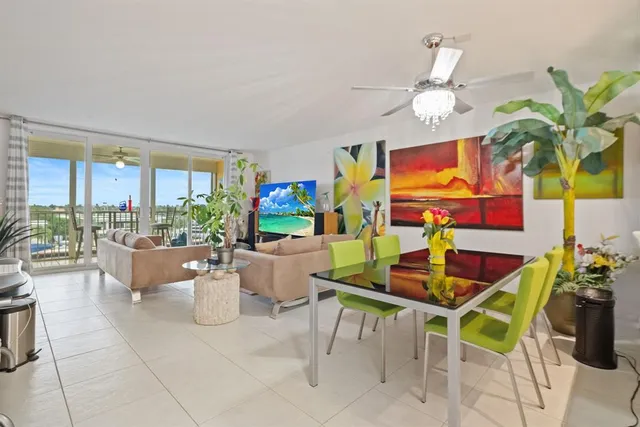 a view of a dining room with furniture a livingroom and chandelier