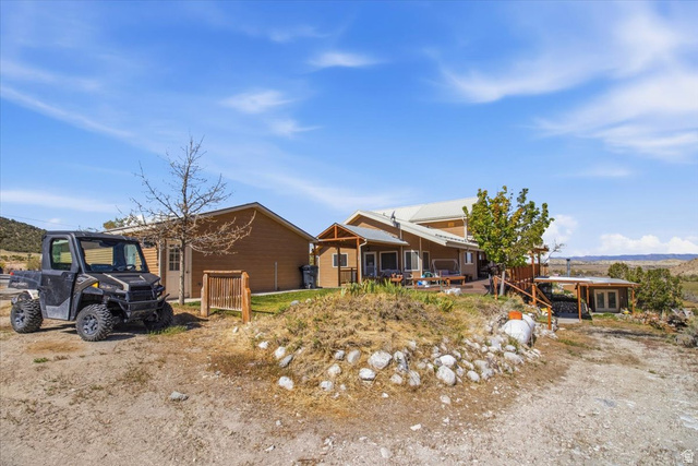 811 East Canyon Road Mayfield, UT 84643 - Photo 42 of 57 Property exterior featuring a multi-level deck, a detached outbuilding, and a metal roof
