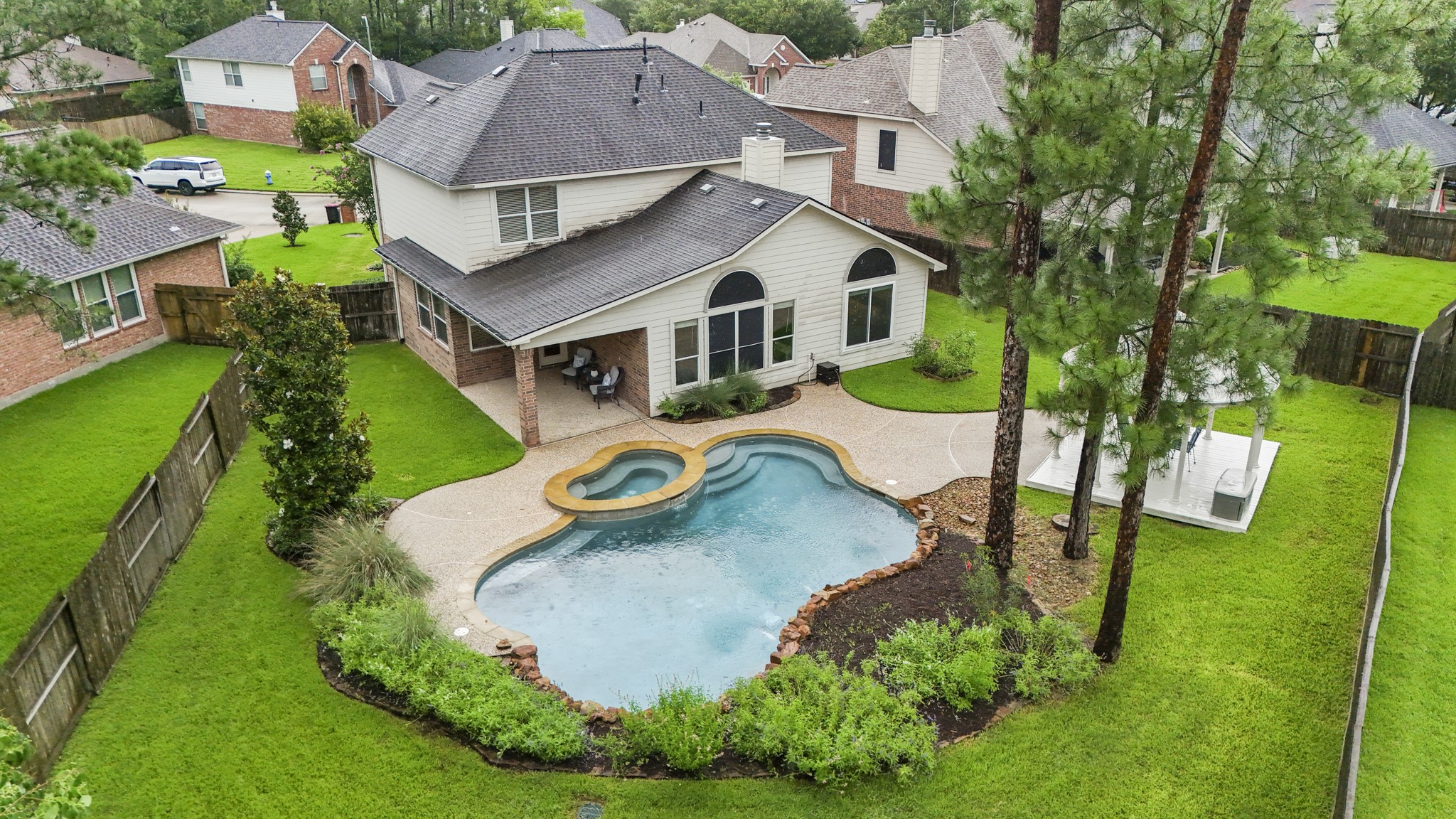 6311 Sparrows Glen Lane Spring, TX 77379 - Photo 38 of 50 From above, the backyard layout comes into full view—covered patio close to the home, pool + spa at the center, gazebo off to the side, and lawn wrapping around the outdoor spaces for a resort-style setting that still feels easy to enjoy.
