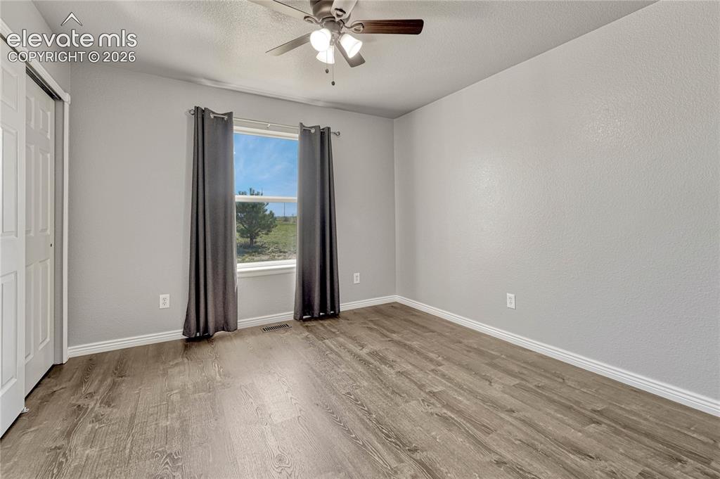 13695 Woodlake Road Elbert, CO 80106 - Photo 24 of 39 Second of two additional main level bedrooms with luxury vinyl flooring.
