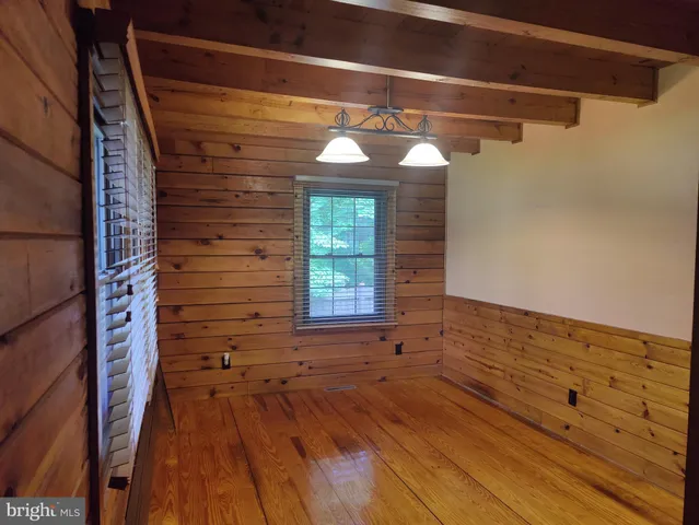 a view of a room with wooden floor and window