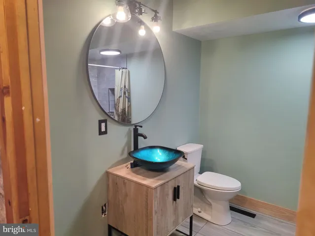 a bathroom with a toilet and a mirror