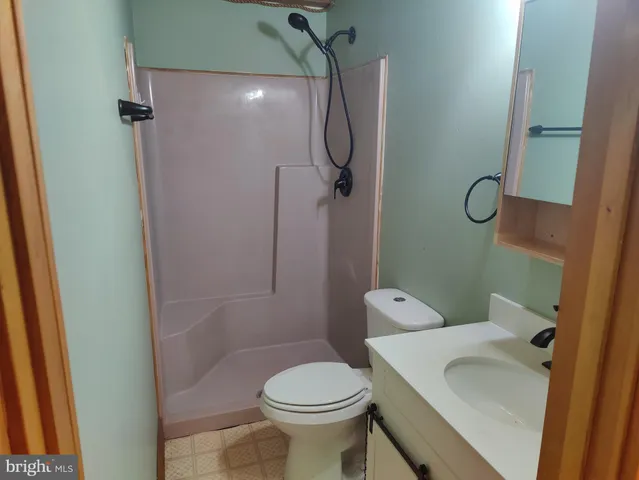 a bathroom with a toilet sink and shower