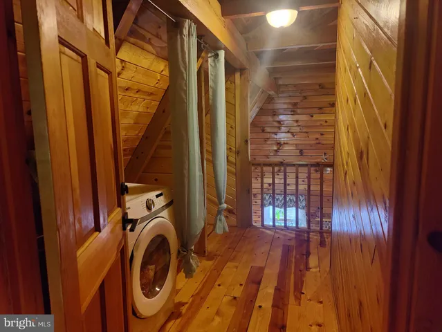 a view of walk in closet with clothes