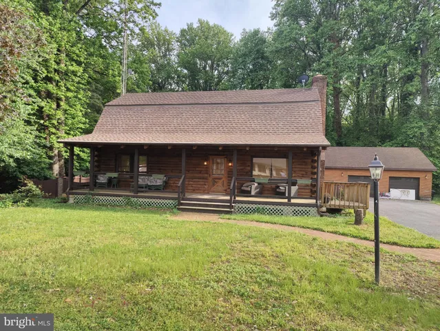 a front view of a house with swimming pool having outdoor seating