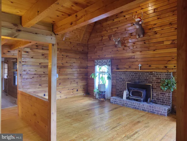 a view of empty room with fireplace and window