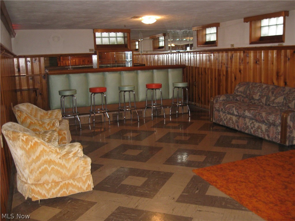 6154 State Road Parma, OH 44134 - Photo 14 of 35 Spacious rec room featuring retro bar with stools and knotty pine walls. All windows are glass block.