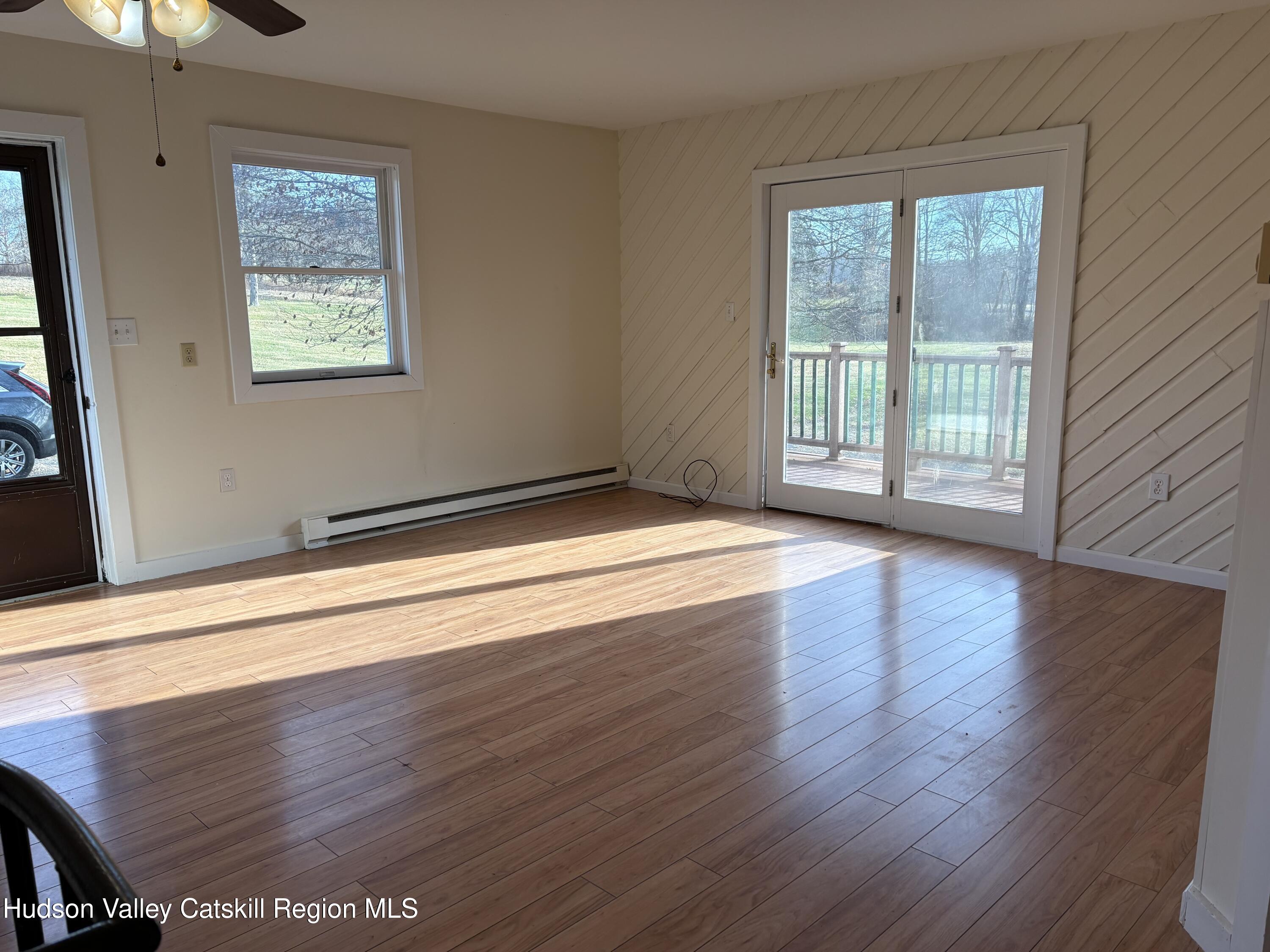 505 Highway 208, Unit 3 Gardiner, NY 12525 - Photo 4 of 11 a view of an empty room with wooden floor and a window